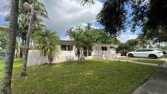 A single-story house with a white exterior, a front lawn, and palm trees — 3000 N 72nd Way, Hollywood FL 33024, HOLLYWOOD, FL