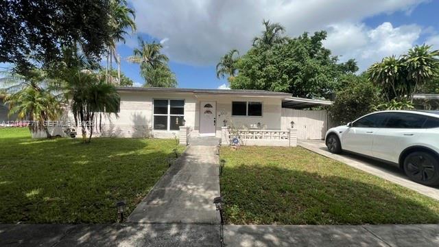 A single-story house with a white exterior, a front walkway, and a parked white car — 3000 N 72nd Way, Hollywood FL 33024, HOLLYWOOD, FL