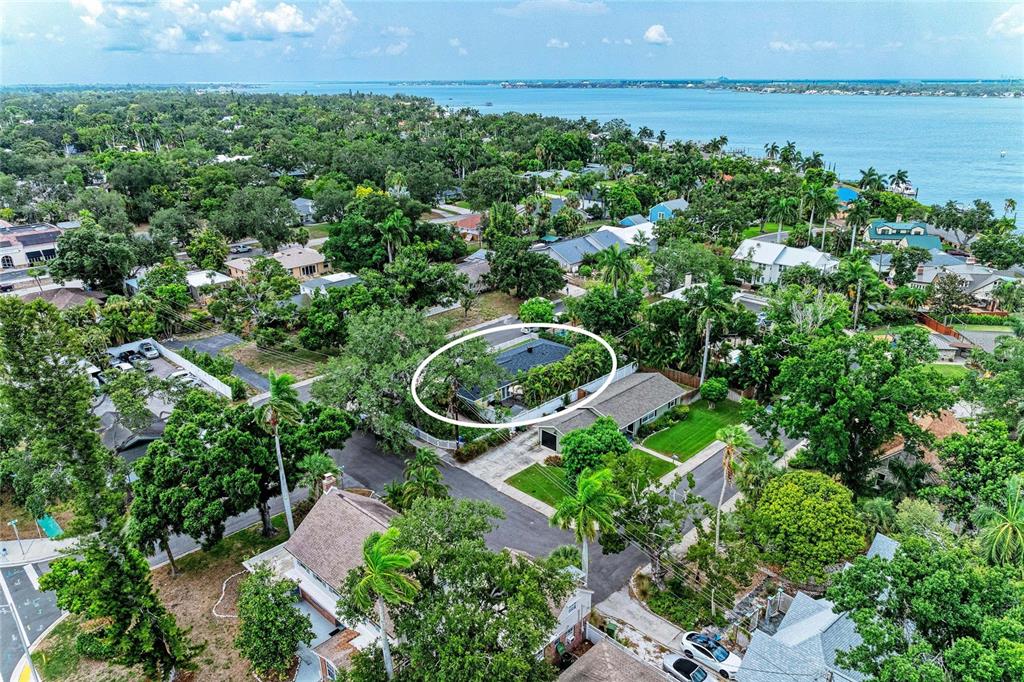 An aerial view shows a residential neighborhood with a house circled in white — 405 20TH STREET W, BRADENTON, FL