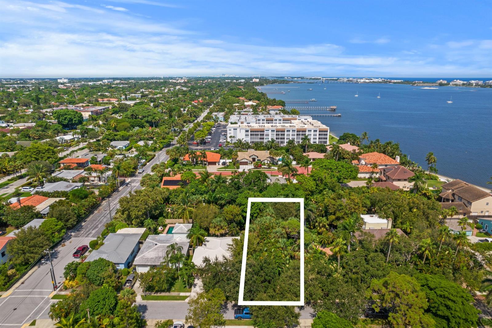 An aerial view shows a rectangular vacant lot surrounded by lush trees in a residential neighborhood — 00 17th Avenue S, FL 33460, FL