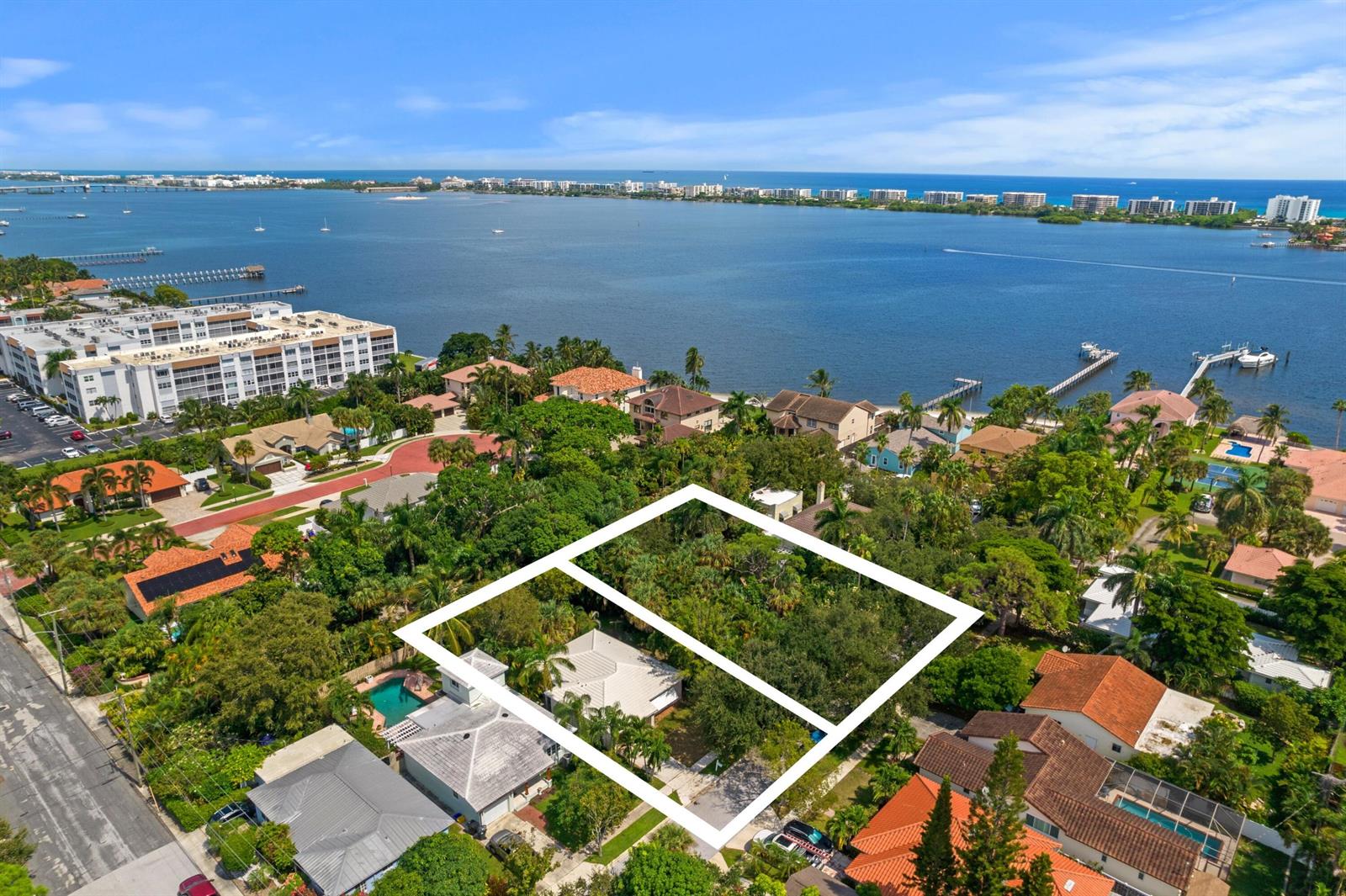 An aerial view shows a residential property with a white outline highlighting two adjacent lots — 00 17th Avenue S, FL 33460, FL