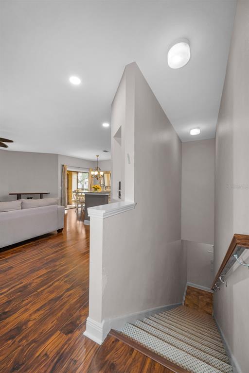 A view from the top of a carpeted staircase looking into a living room area — 2199 CHIANTI PLACE UNIT 9-0925, PALM HARBOR, FL