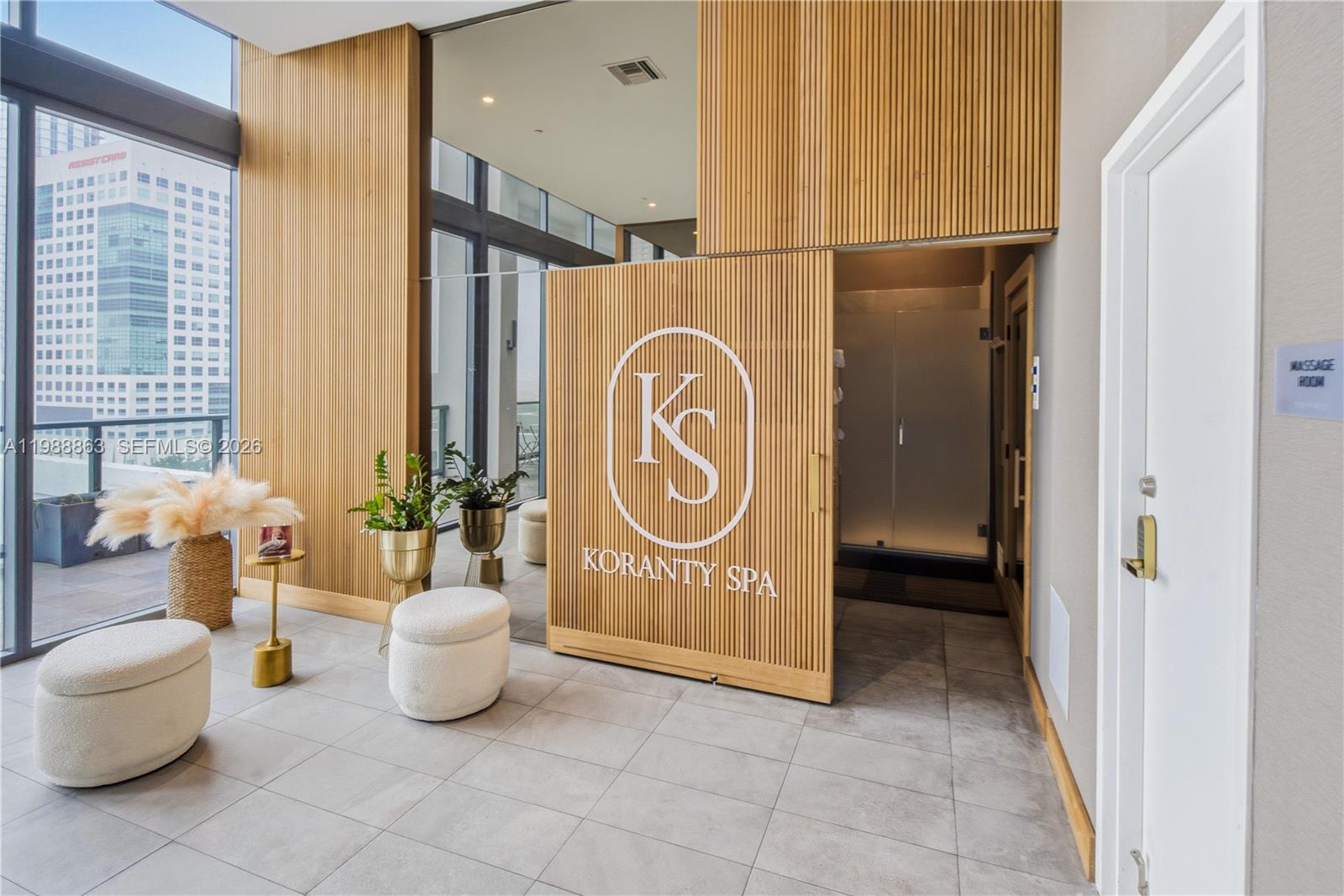A modern spa entrance features a slatted wood wall with a logo and glass doors — 239 SW 9th St # 802, Miami FL 33130, MIAMI, FL