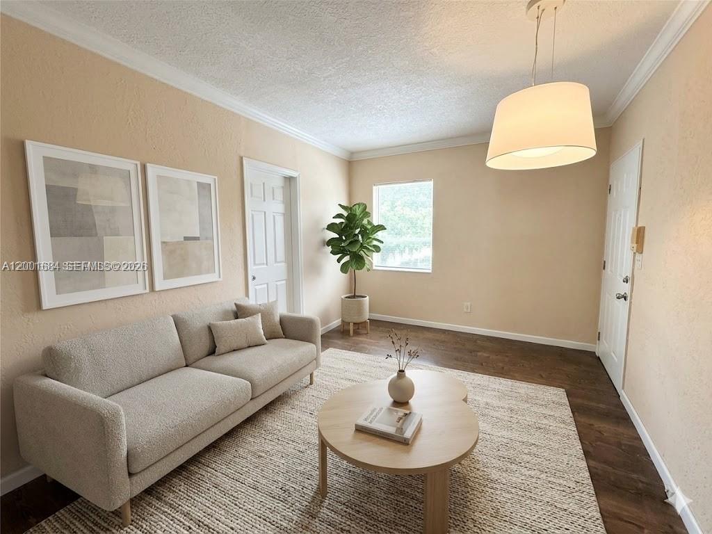 A living room features a light-colored sofa, a round coffee table, and a potted plant — 620 84th St # 25, Miami Beach FL 33141, MIAMI BEACH, FL