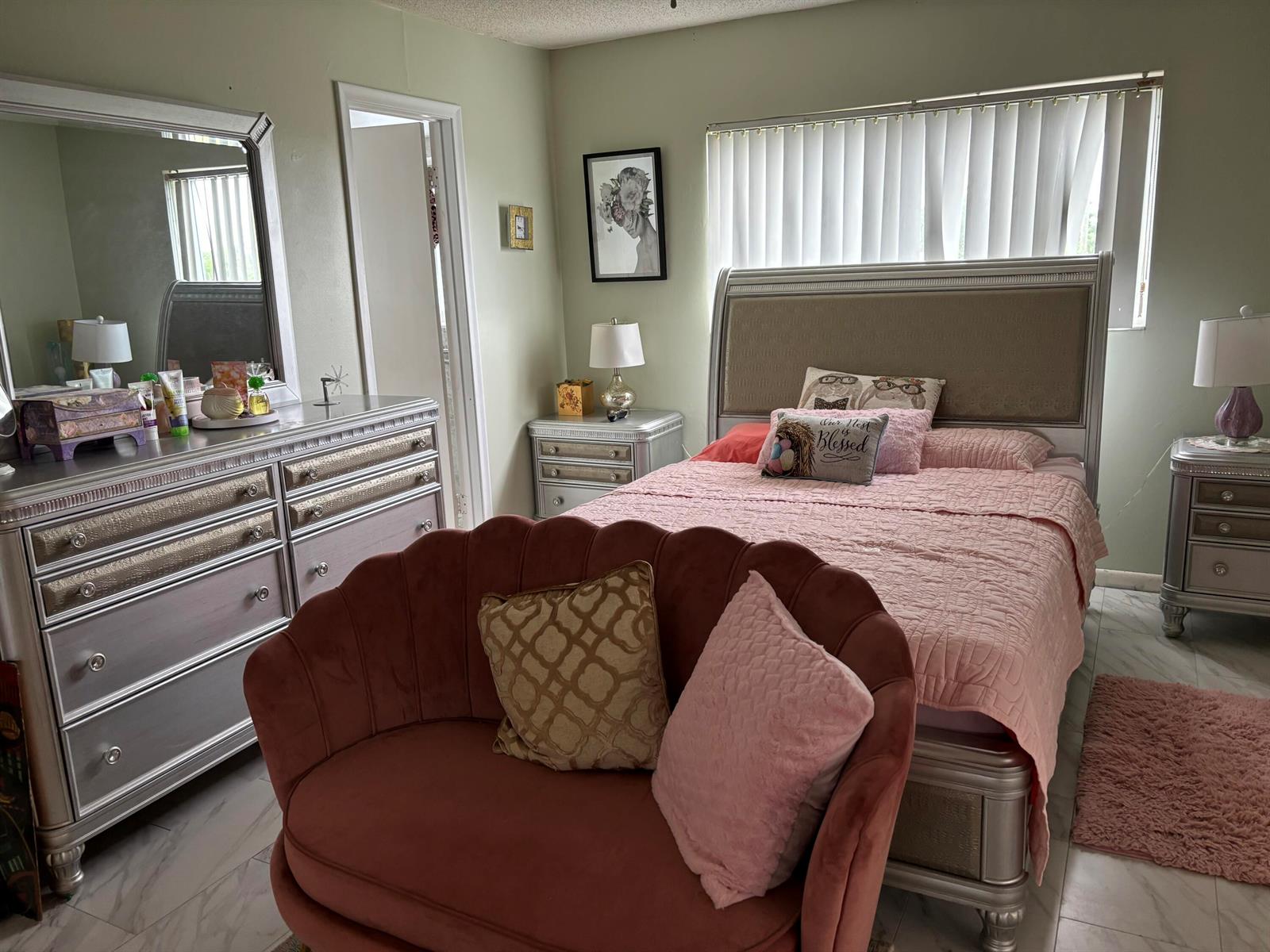 A bedroom features a silver bed frame, matching dresser, and a pink velvet scalloped loveseat — 326 Andover, West Palm Beach FL 33417, WEST PALM BEACH, FL