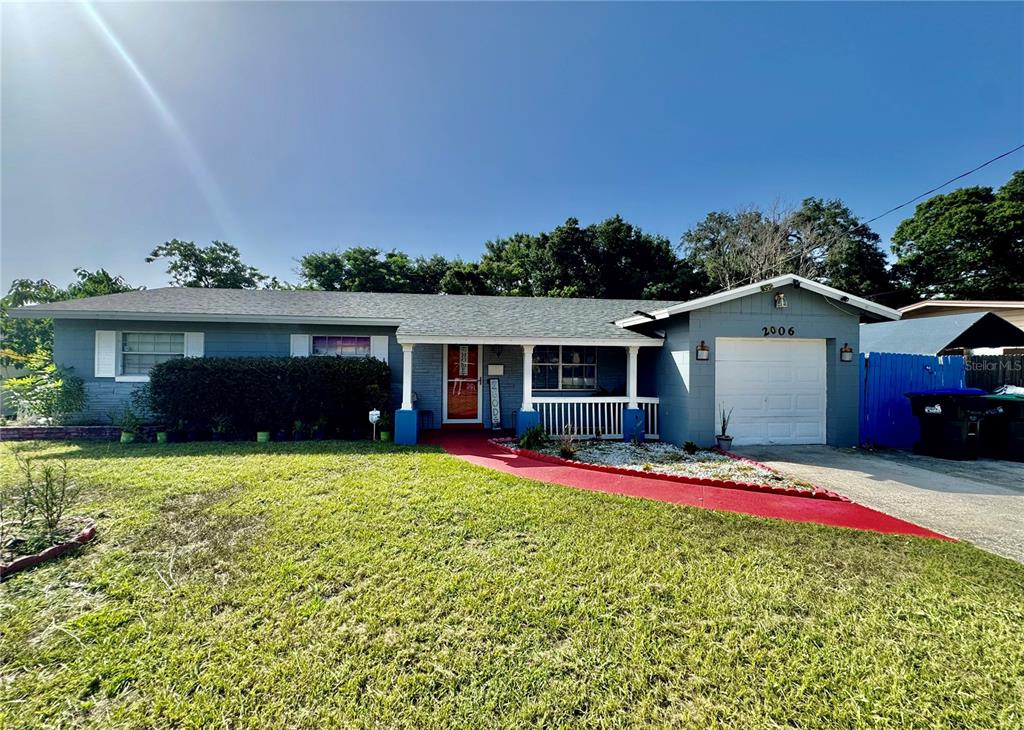A single-story blue house features a red walkway, a front porch, and a one-car garage — 2006 SARAZEN DRIVE, ORLANDO, FL