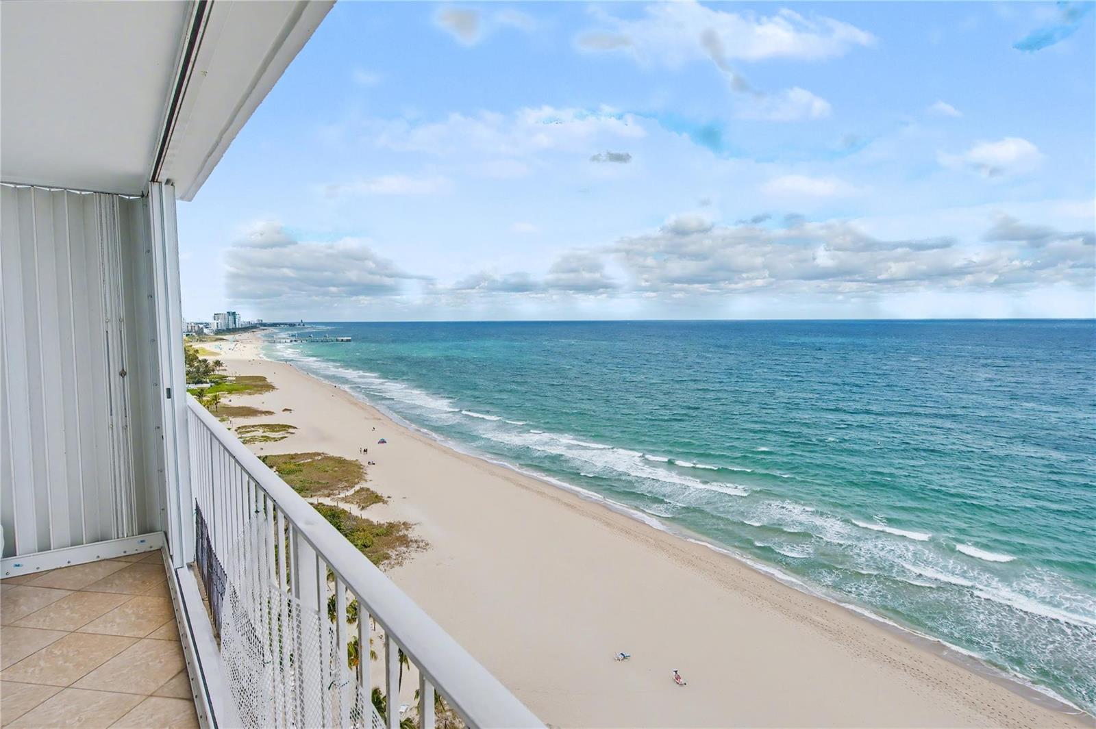 A high-angle view from a balcony overlooking a sandy beach and the ocean — 1010 S Ocean Boulevard # 1601, Pompano Beach FL 33062, POMPANO BEACH, FL