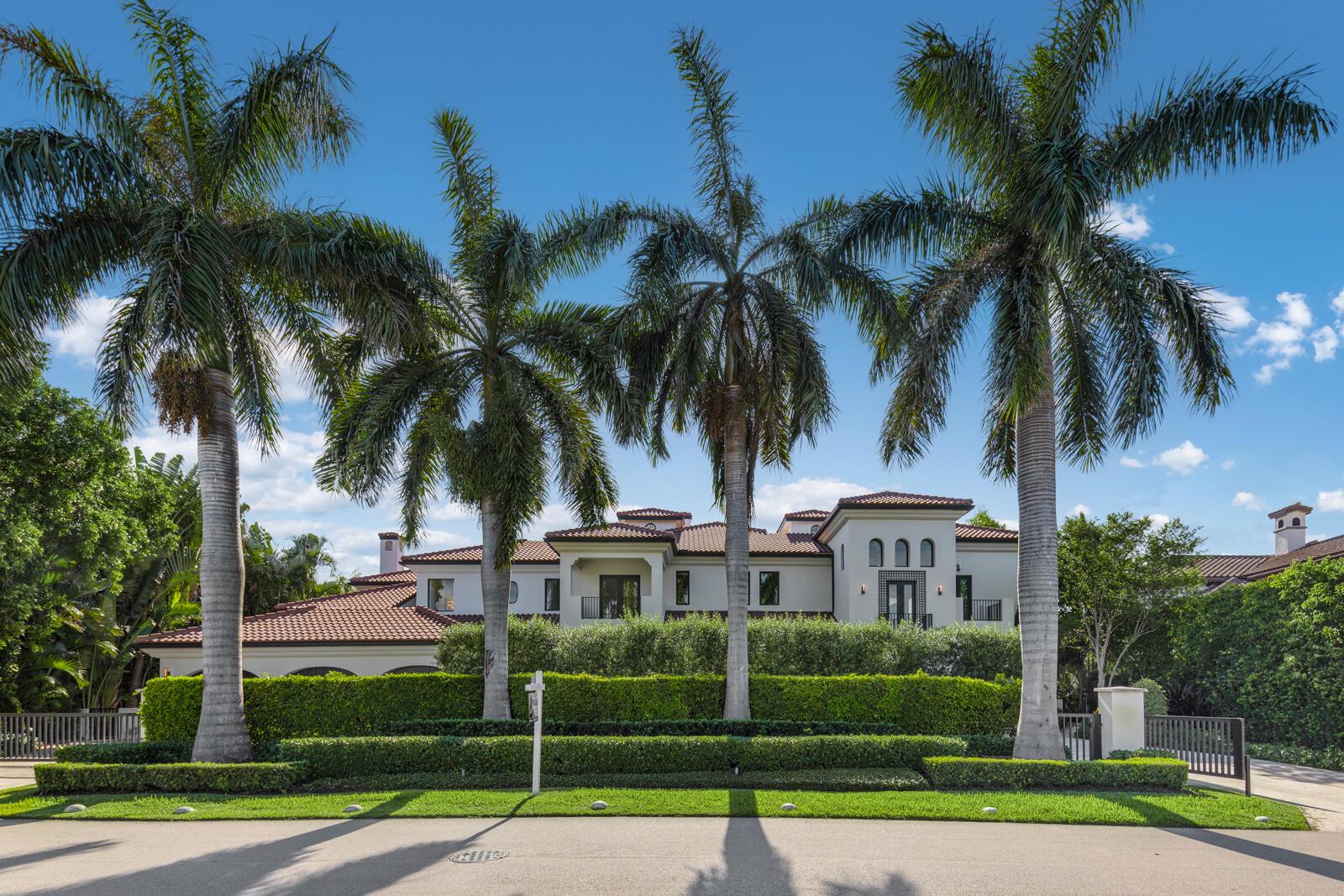 A large Mediterranean-style house sits behind a manicured hedge and three tall palm trees — 1207 Spanish River Road, Boca Raton FL 33432, BOCA RATON, FL