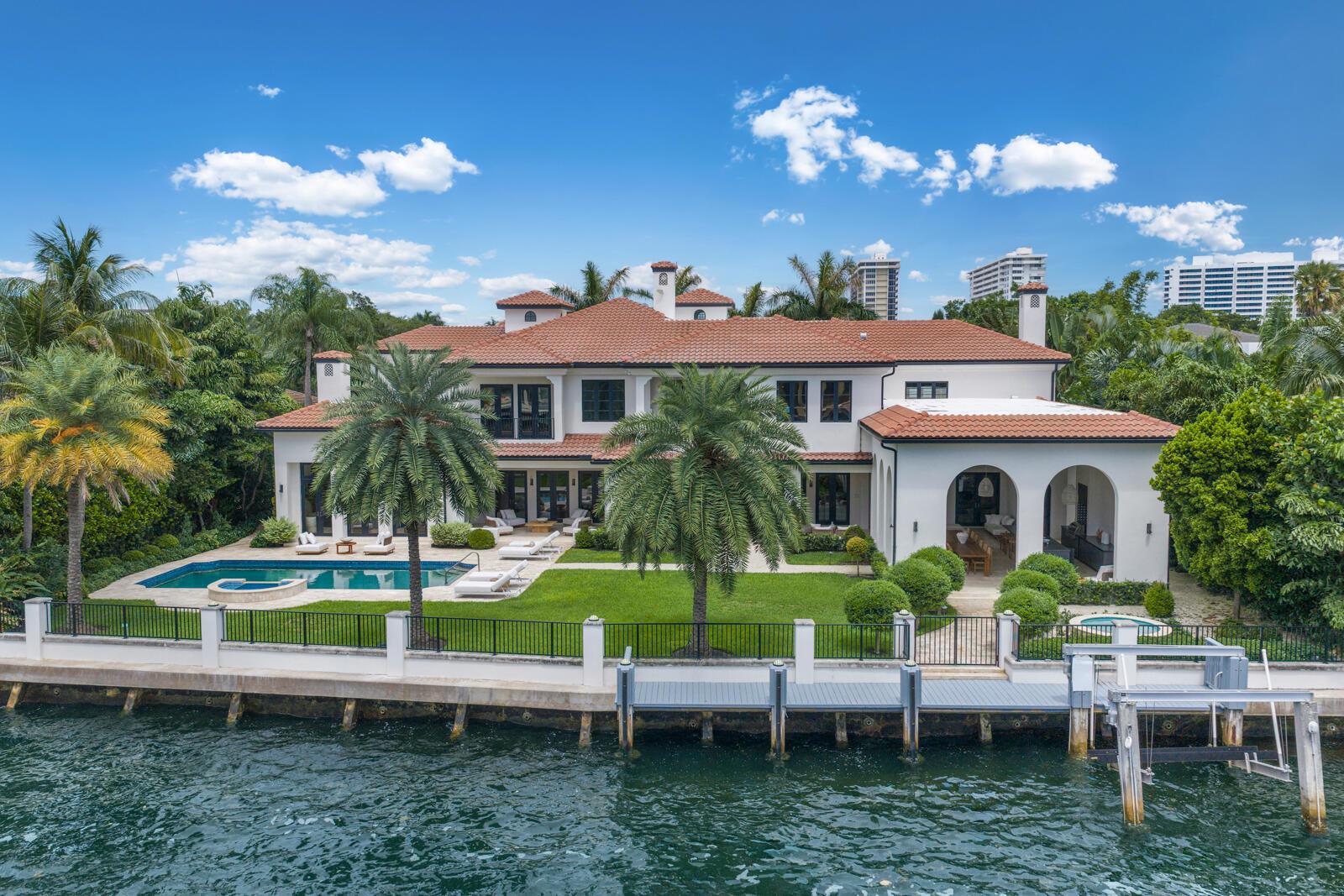 An aerial view of a waterfront mansion with a pool, lawn, and private boat dock — 1207 Spanish River Road, Boca Raton FL 33432, BOCA RATON, FL