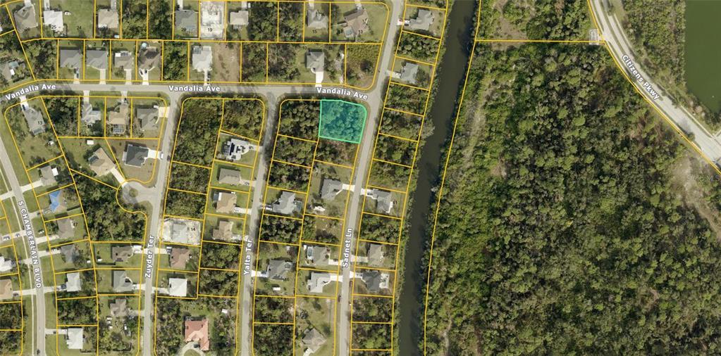 This is an aerial map showing a vacant, highlighted residential lot in a suburban neighborhood — LOT 9 SADNET LANE, NORTH PORT, FL