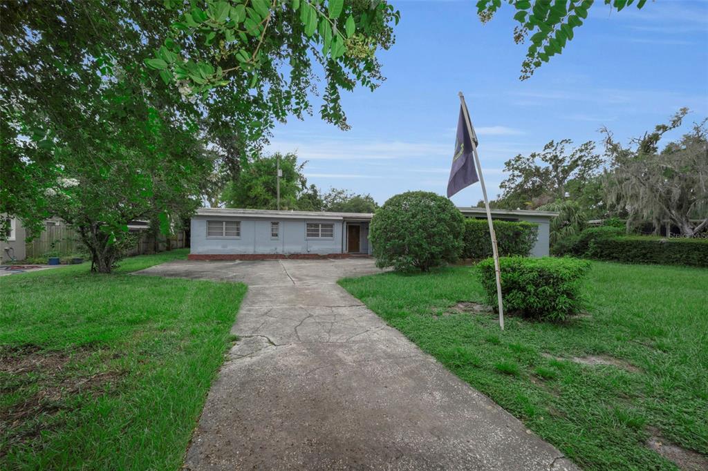 A single-story house with a concrete driveway and a flag pole in the front yard — 509 BROXBURN AVENUE, TAMPA, FL