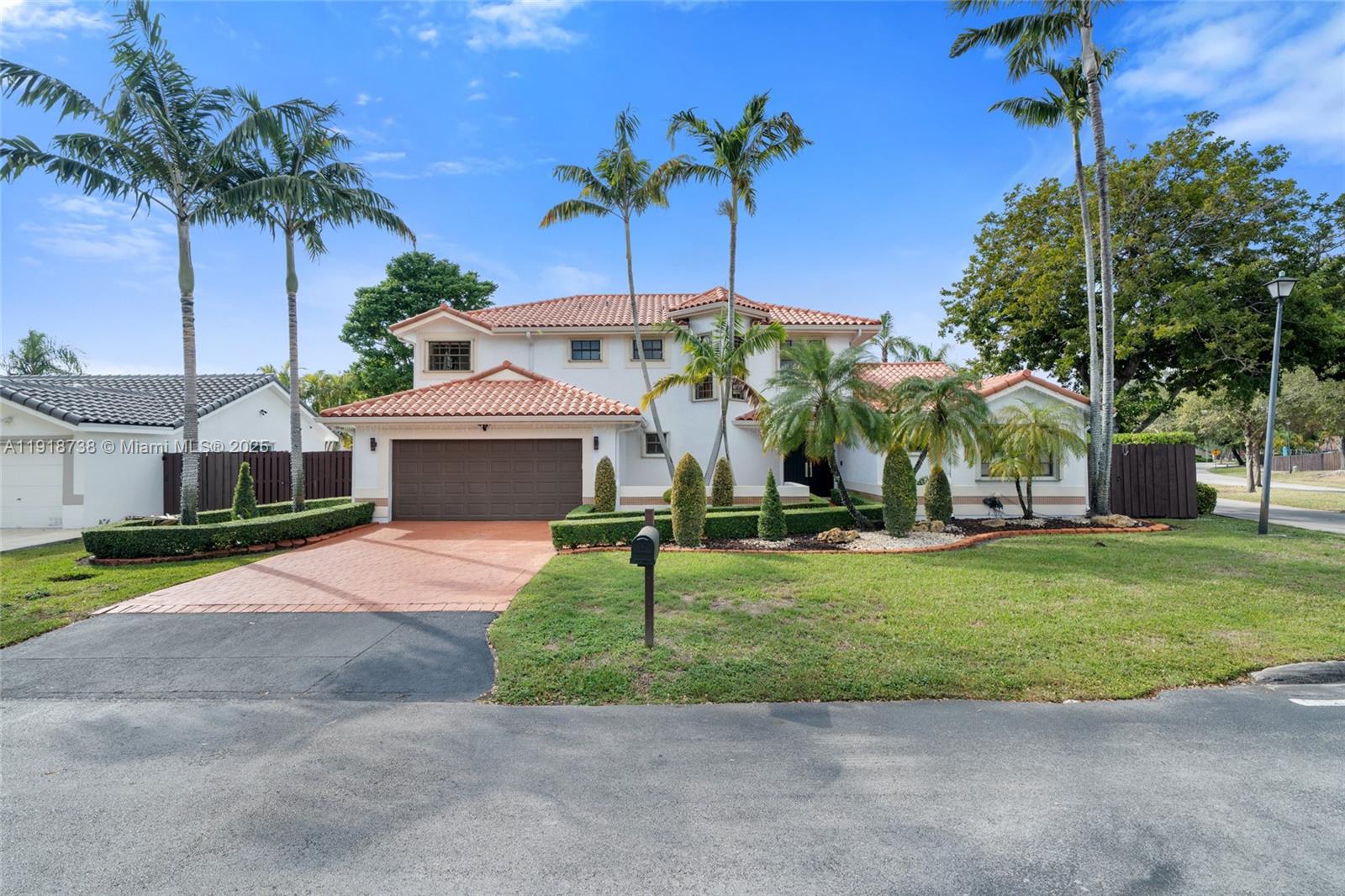 A two-story house with a tile roof, brown garage door, and palm trees in the yard — 5424 SW 154th Pl # 5424, Miami FL 33185, MIAMI, FL