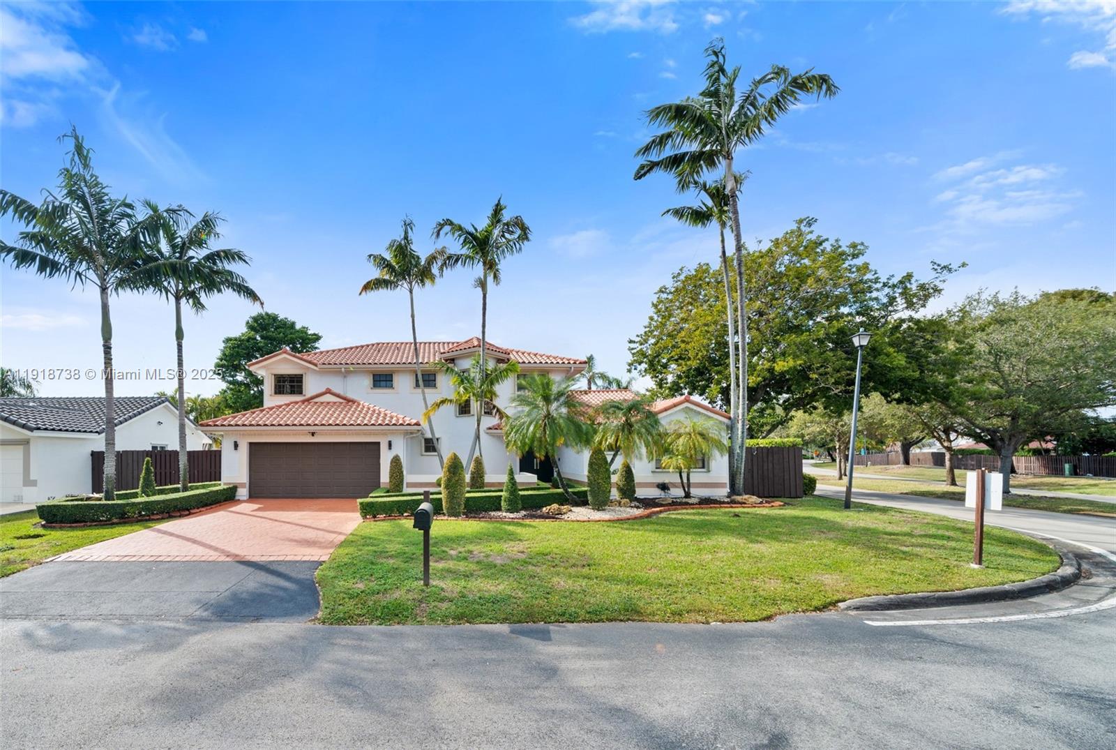 A two-story house with a tile roof, brown garage, and palm trees in the yard — 5424 SW 154th Pl # 5424, Miami FL 33185, MIAMI, FL