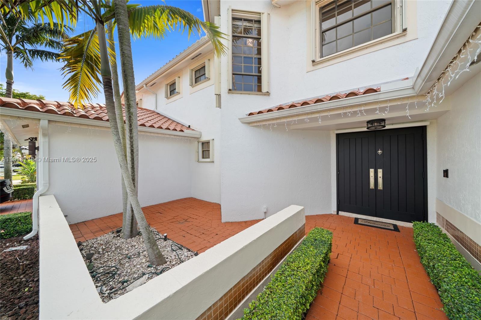The exterior view shows a white house with a tiled roof, palm trees, and brick walkway — 5424 SW 154th Pl # 5424, Miami FL 33185, MIAMI, FL