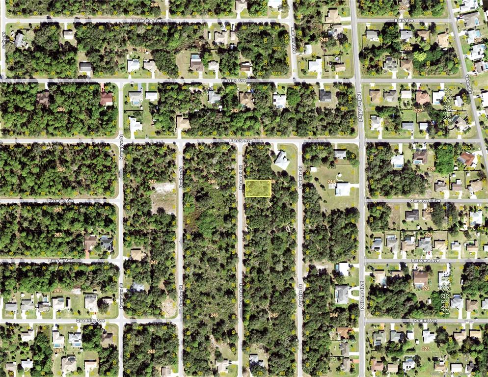 This is an aerial map showing a vacant lot highlighted in yellow within a residential neighborhood — 3288 MONARCH STREET, PORT CHARLOTTE, FL