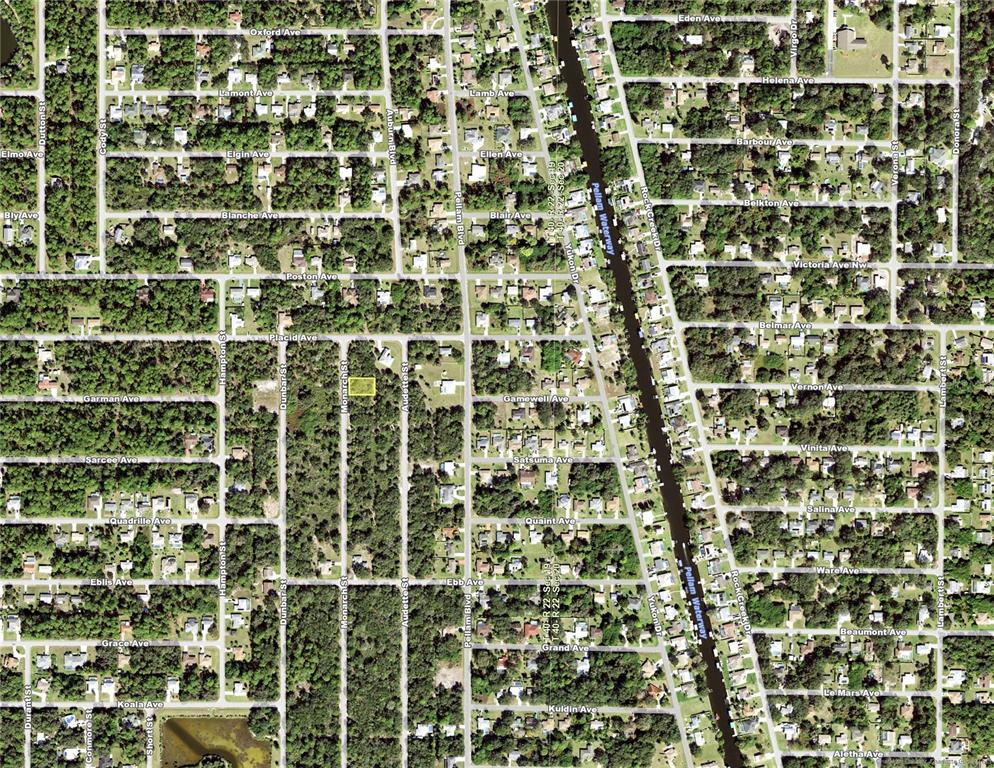 This is an aerial map showing a highlighted vacant lot surrounded by residential streets and vegetation — 3288 MONARCH STREET, PORT CHARLOTTE, FL