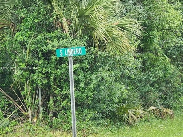 A street sign reading S Lindero stands in front of dense green foliage and palm trees — 375 Montura Ave., Clewiston FL 33440, CLEWISTON, FL