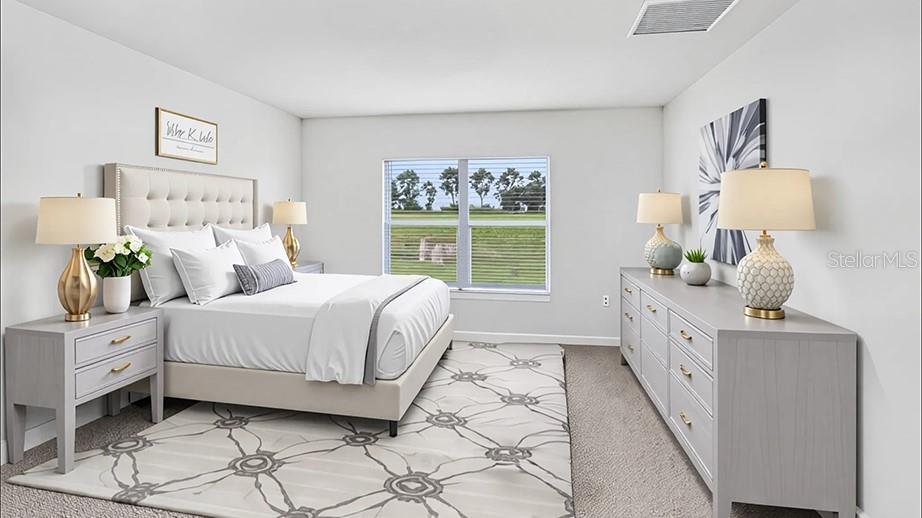 A bedroom features a tufted headboard, a gray dresser, and a large window overlooking grass — 5385 SW 41ST COURT, OCALA, FL