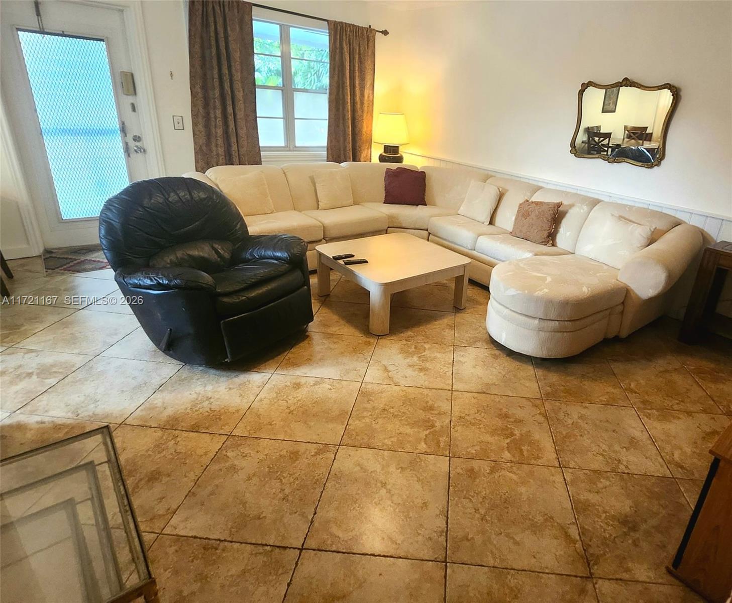 A living room features a large sectional sofa, a black recliner, and tiled flooring — 564 Durham T # 564, Deerfield Beach FL 33442, DEERFIELD BEACH, FL