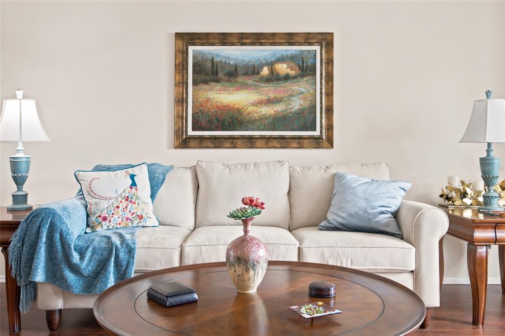 A bedroom features a wooden bed frame, matching dressers, a ceiling fan, and sliding glass doors — 2292 WHISPER WALK DRIVE, SPRING HILL, FL