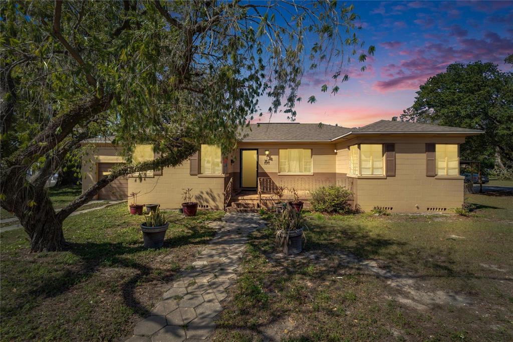 A single-story, tan-colored concrete block house with a front walkway and a large tree — 2606 N BOULEVARD, TAMPA, FL