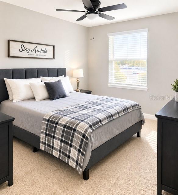 A bedroom features a gray upholstered bed, a ceiling fan, and a window with blinds — 4208 DOVETAIL LANE, PALMETTO, FL