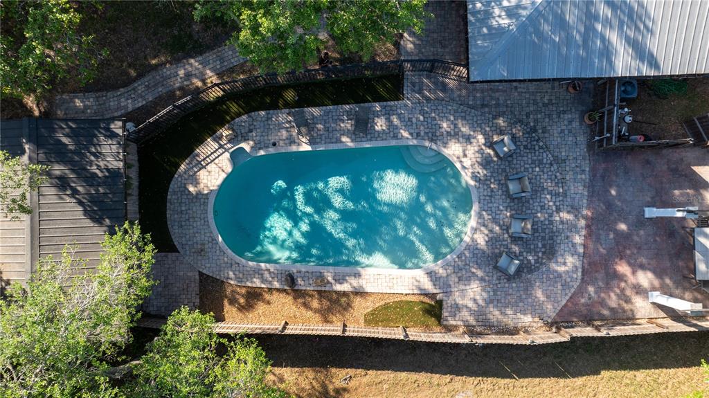 An aerial view of a backyard swimming pool surrounded by a paver patio and fencing — 5160 HAYWOOD RUFFIN ROAD, ST CLOUD, FL