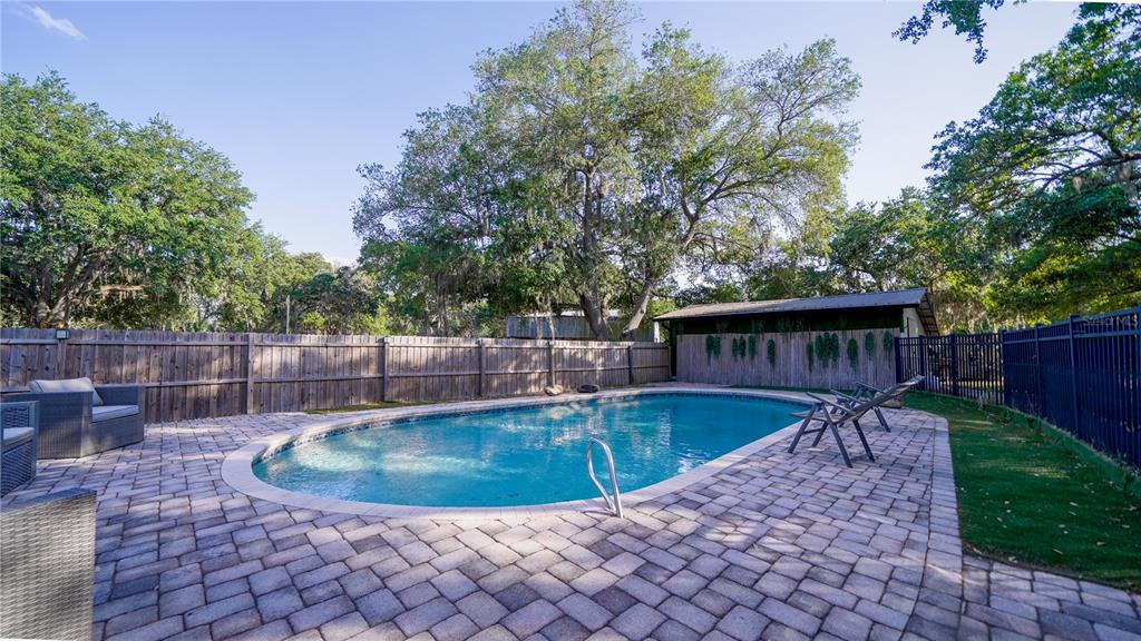 A dining area features a white door with decorative glass, tile flooring, and a sliding door — 5160 HAYWOOD RUFFIN ROAD, ST CLOUD, FL