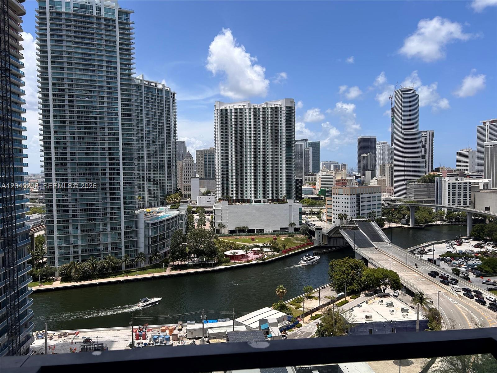 A high-angle view of a Miami cityscape featuring skyscrapers, a river, and a drawbridge — 88 SW 7th St # 1511, Miami FL 33130, MIAMI, FL