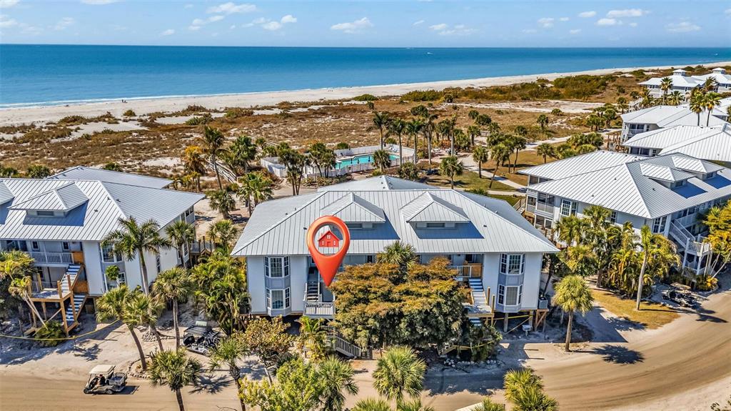 An aerial view shows a multi-story coastal building with a red location pin marker — 7454 PALM ISLAND DRIVE UNIT 3311, PLACIDA, FL