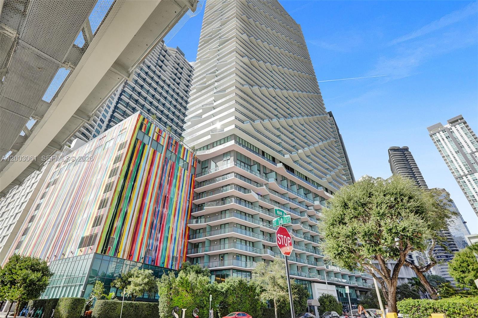 A low-angle exterior view shows the modern SLS hotel building with a restaurant entrance — 1300 S Miami Ave # 3111, Miami FL 33130, MIAMI, FL