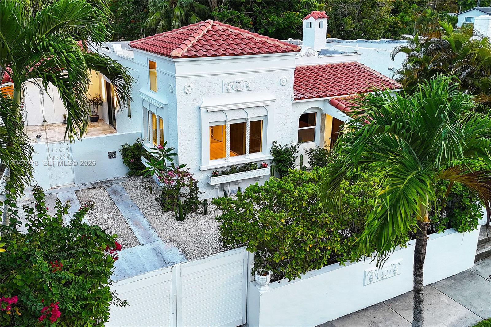 An aerial view of a white stucco house with a red tile roof and landscaping — 3616 SW 26th St, Miami FL 33133, MIAMI, FL