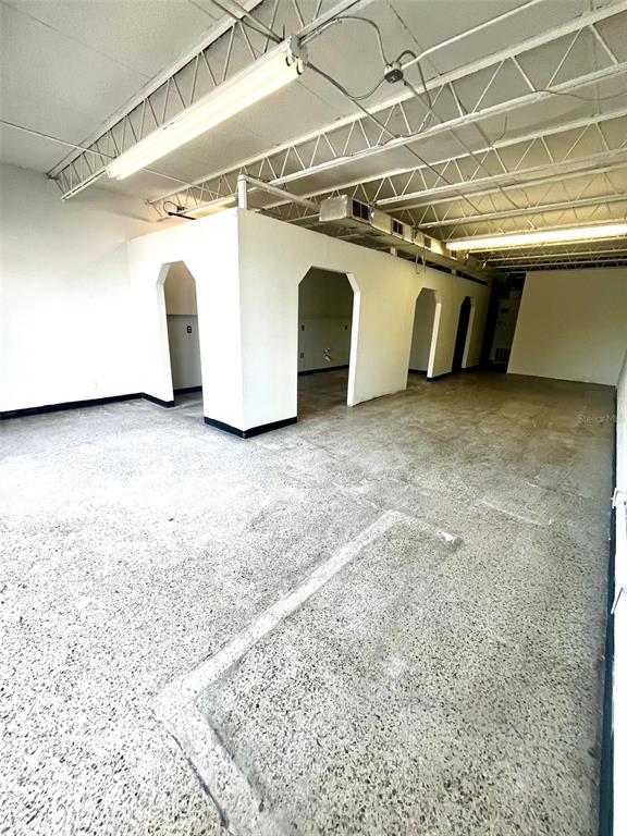 An interior view of a commercial space with concrete floors and white partition walls — 6024 SEMINOLE BOULEVARD, SEMINOLE, FL