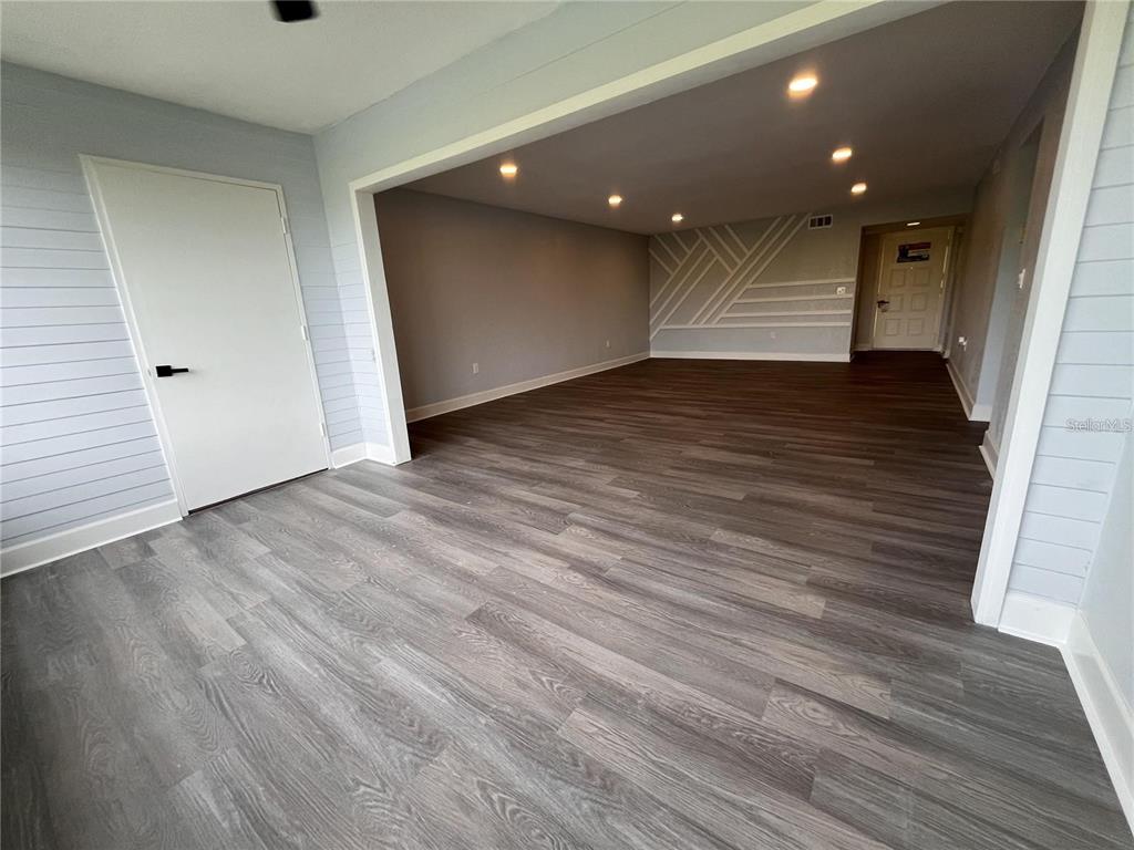 An interior view showing a room with wood-look flooring, light blue shiplap walls, and recessed lighting — 314 SPRING LAKES BOULEVARD UNIT 314-U, BRADENTON, FL
