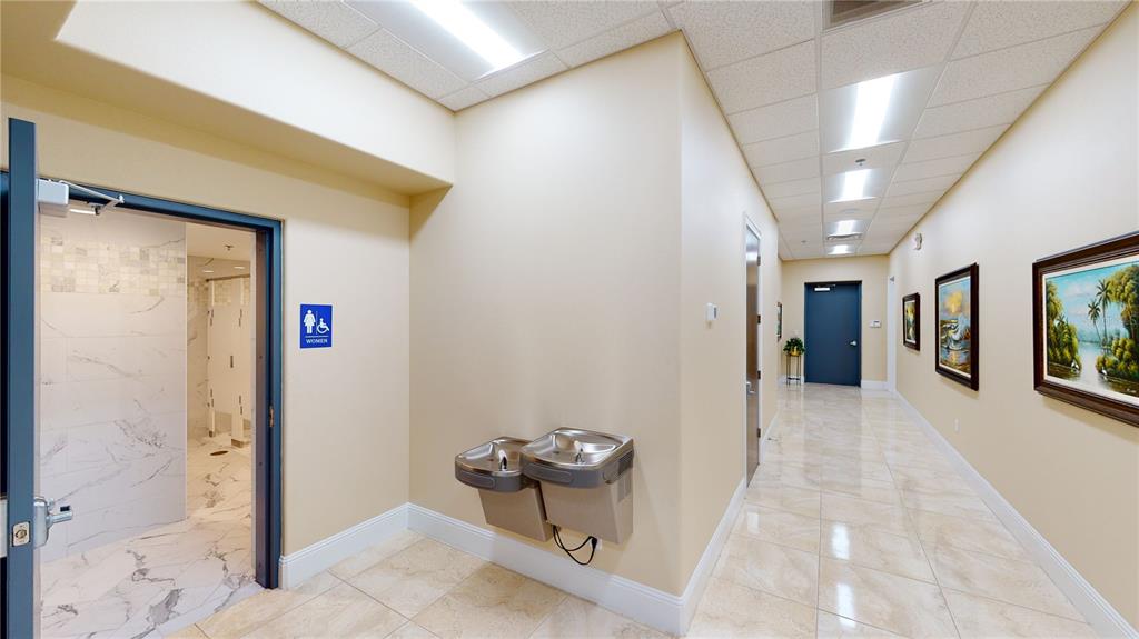 A hallway with tile floors, a women's restroom, and a dual-level water fountain — 350 ANCHOR ROAD ROAD UNIT 1040, CASSELBERRY, FL