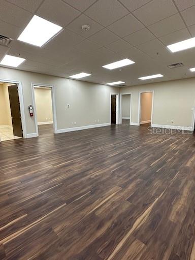 An empty office space features light-colored walls, a drop ceiling with recessed lighting, and wood-look flooring — 350 ANCHOR ROAD ROAD UNIT 1040, CASSELBERRY, FL