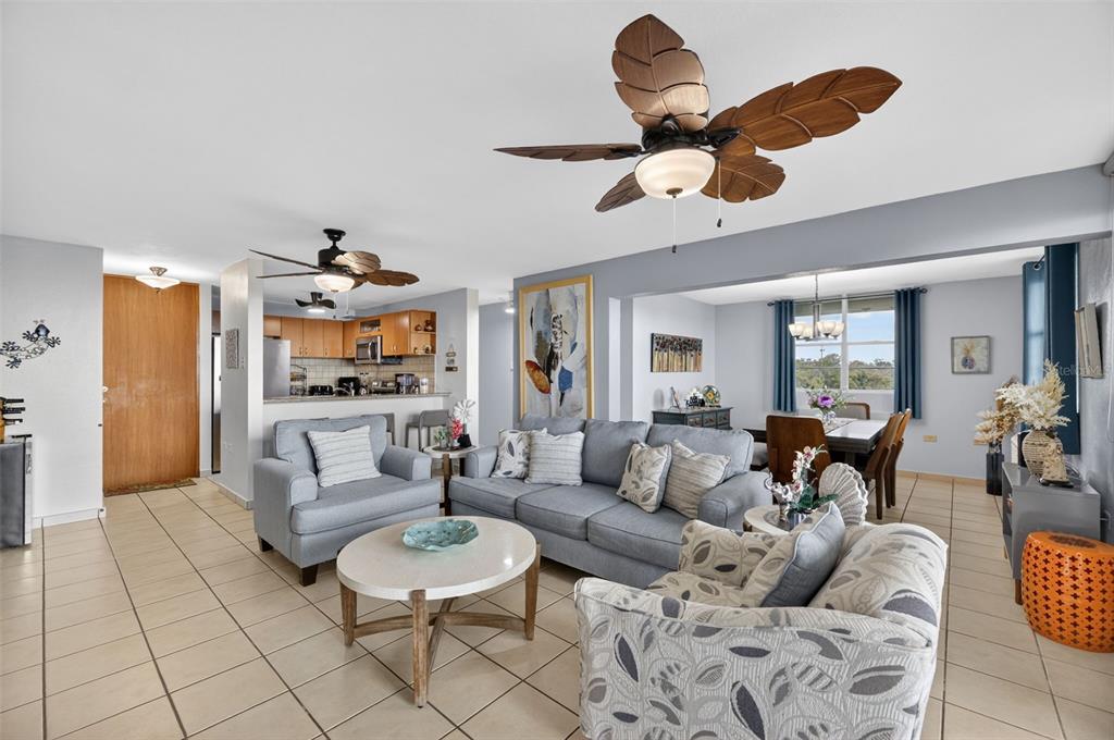 An open-concept living and dining area features tile floors, two ceiling fans, and neutral furniture — Route 102 TORRE MARSELLA CONDOMINIUM UNIT 601, CABO ROJO, PR