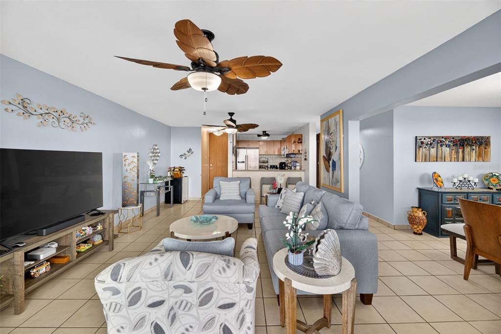 A living room features light blue walls, tile flooring, a palm-leaf ceiling fan, and furniture — Route 102 TORRE MARSELLA CONDOMINIUM UNIT 601, CABO ROJO, PR