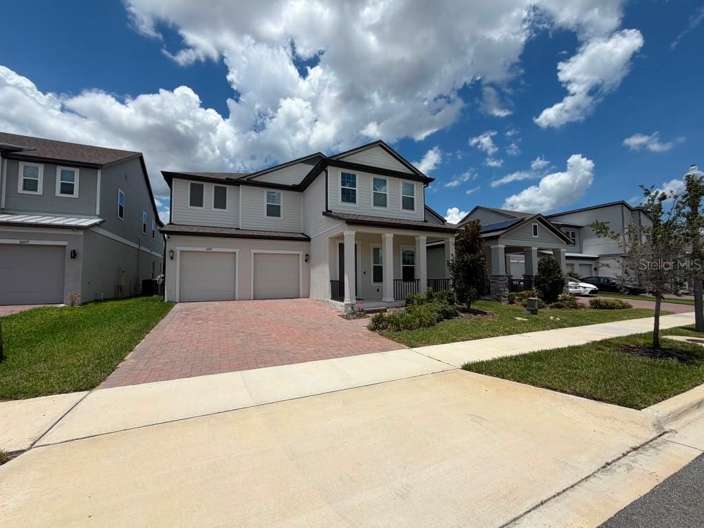 A two-story suburban house with a two-car garage and a paved driveway — 16091 SILVER BROOK WAY, WINTER GARDEN, FL