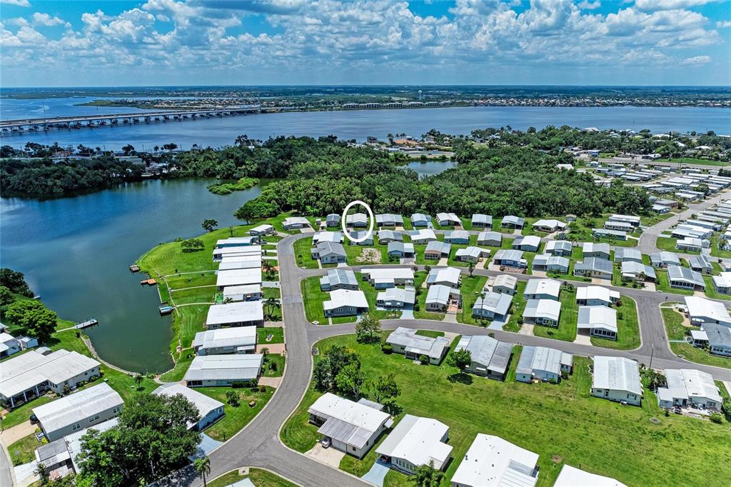 An aerial view shows a mobile home community situated along a lake and bridge — 4543 12TH STREET COURT E, ELLENTON, FL