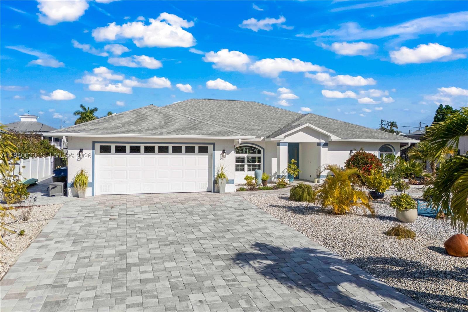 A single-story house with a white exterior, gray shingled roof, and a paved driveway — OTHER CITY - IN THE STATE OF FLORIDA, FL