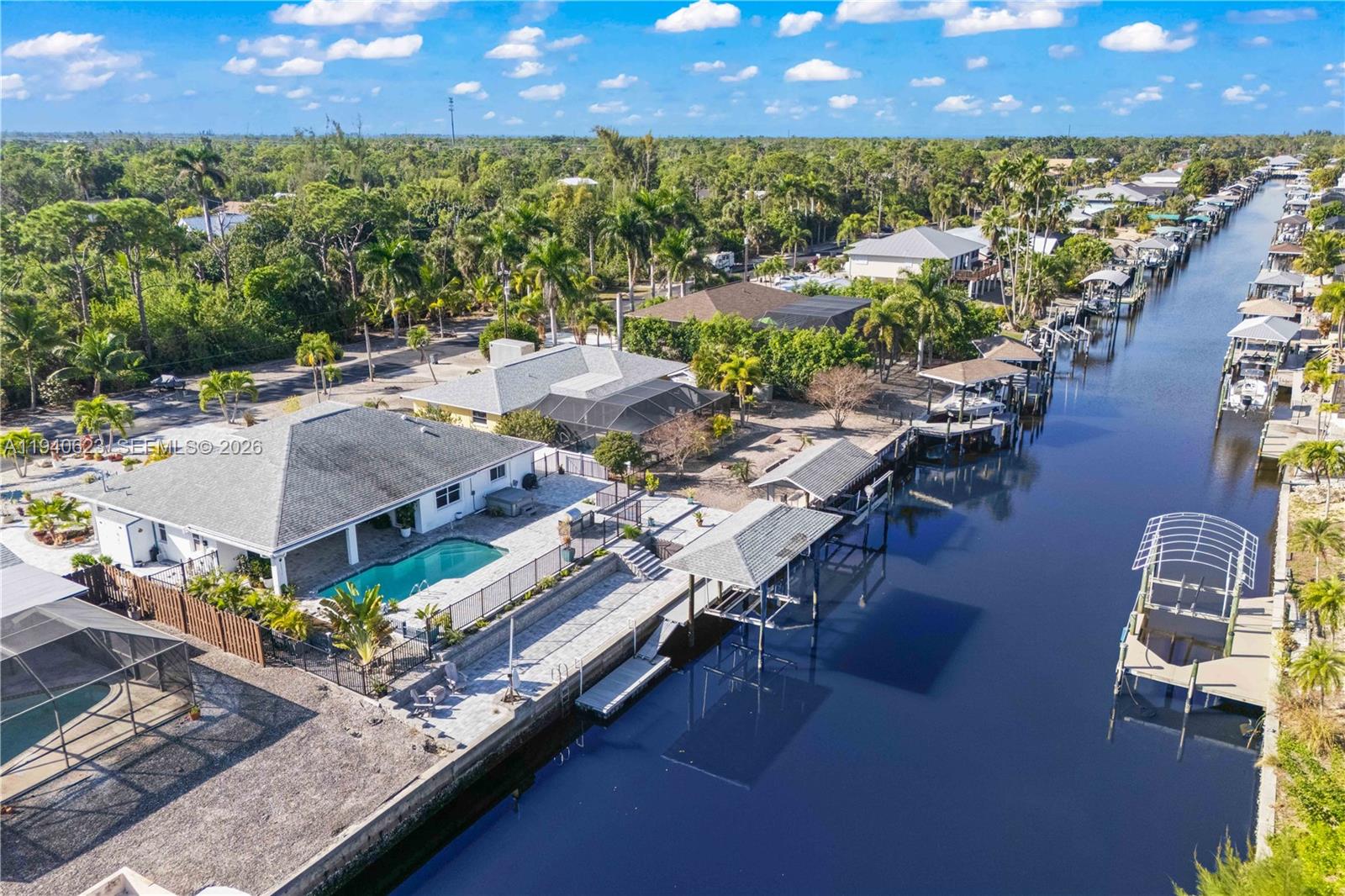 An aerial view shows a waterfront house with a swimming pool and private boat dock — OTHER CITY - IN THE STATE OF FLORIDA, FL