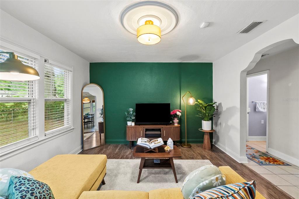 A kitchen features dark wood cabinets, granite countertops, white subway tile backsplash, and black appliances — 2016 E POWHATAN AVENUE, TAMPA, FL