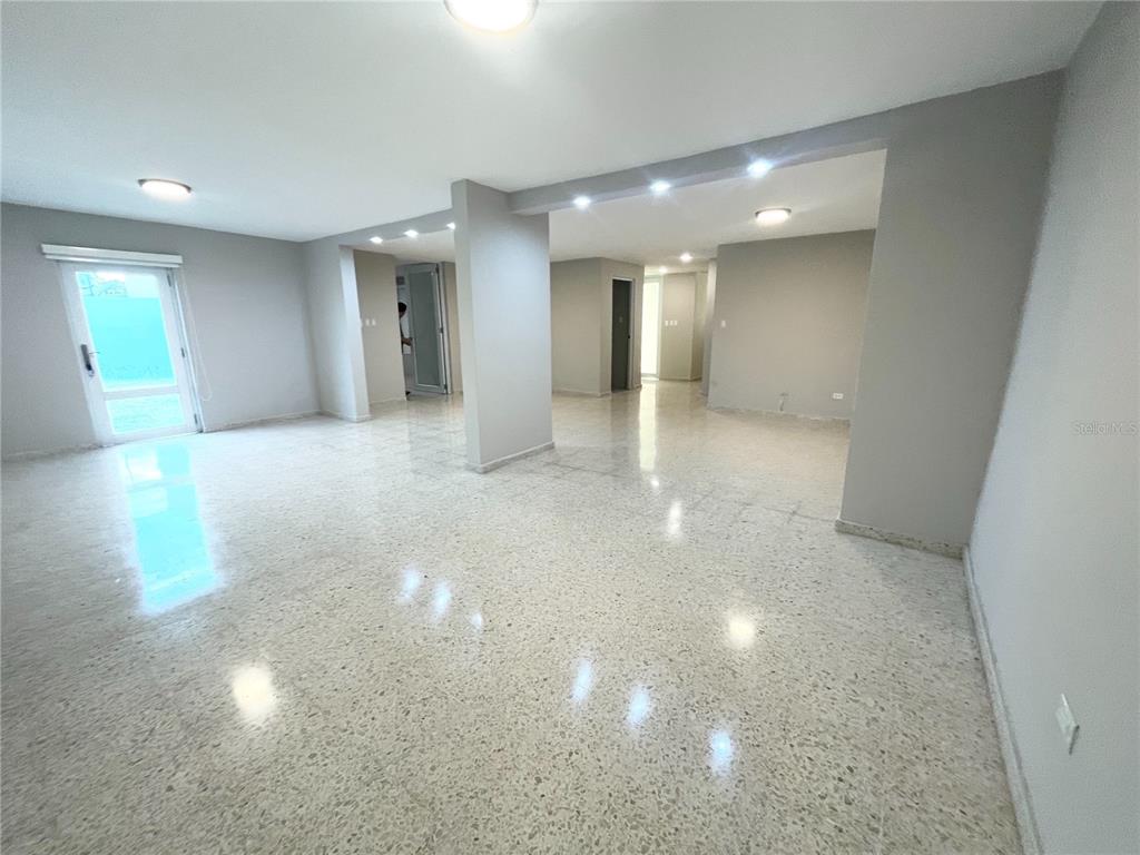 An open-concept room features light gray walls, recessed lighting, and polished speckled tile flooring — URB. VALLE REAL, INFANTA ST. UNIT 1826, PONCE, PR