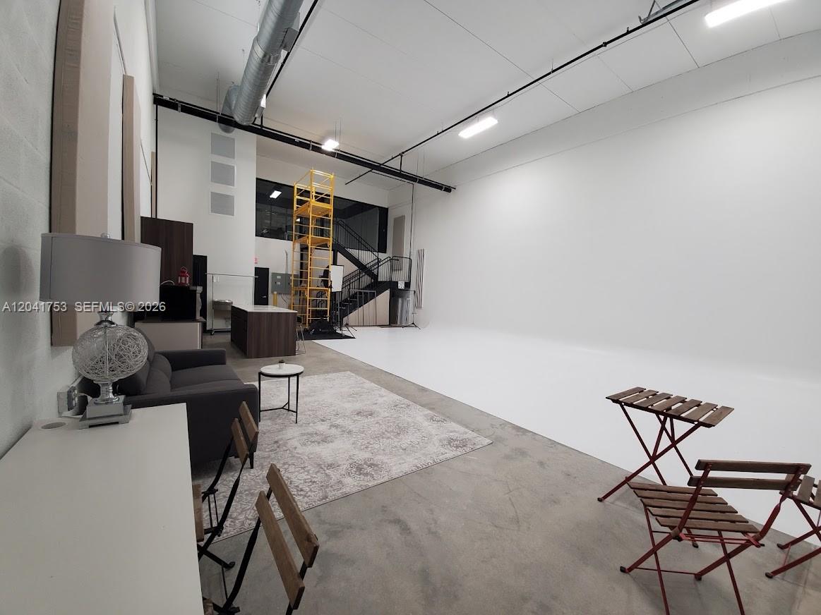 A spacious studio with a white cyclorama wall, concrete floors, and a mezzanine level — 2017 NW 135 Avenue, Miami FL 33182, MIAMI, FL