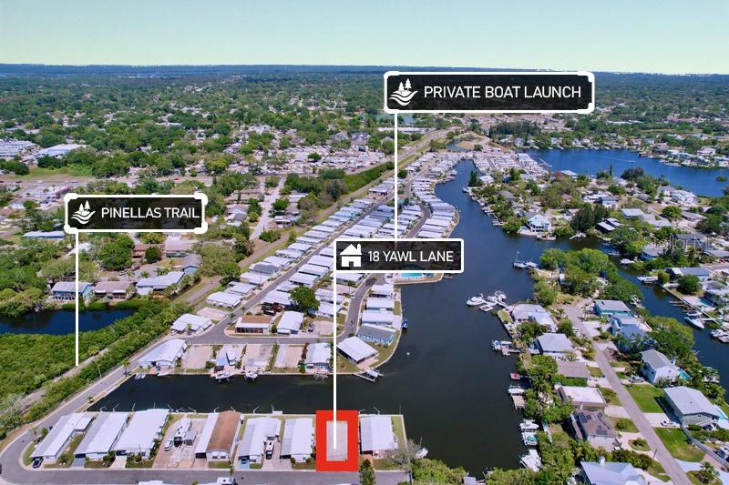 This aerial map shows a residential waterfront community with a highlighted property lot — 18 YAWL LANE UNIT 18, PALM HARBOR, FL