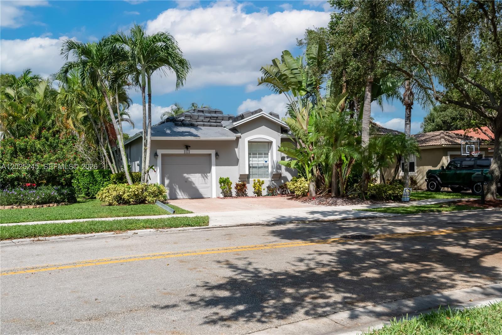 A single-story gray house with a garage and a roof undergoing repairs — 4123 Sapphire Bnd, Weston FL 33331, WESTON, FL