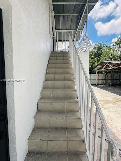 An exterior staircase with white railings leads up to a covered landing — 11870 SW 5th St # B, Miami FL 33184, MIAMI, FL