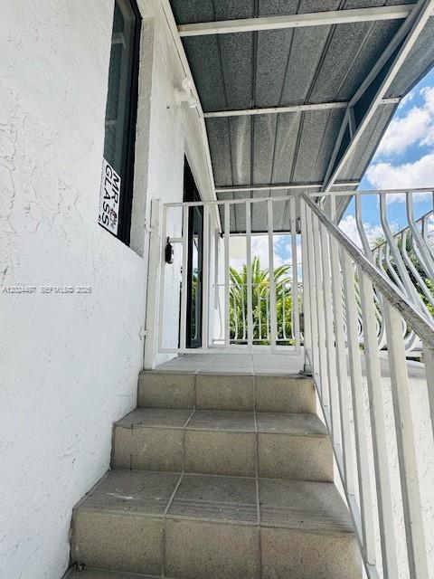 Concrete stairs lead up to a white metal gate and a covered exterior entryway — 11870 SW 5th St # B, Miami FL 33184, MIAMI, FL