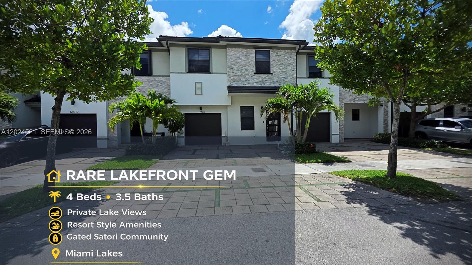 The exterior view shows a two-story townhouse with a stone facade and a paved driveway — 16017 NW 91st Ct, Miami Lakes FL 33018, MIAMI LAKES, FL